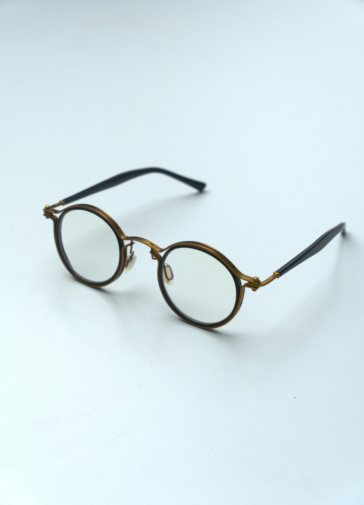Round eyeglasses with metal frames on white background