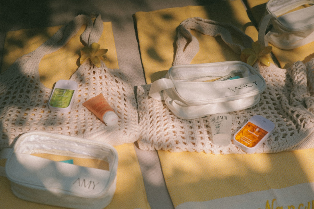 Beach essentials laid out on yellow towels