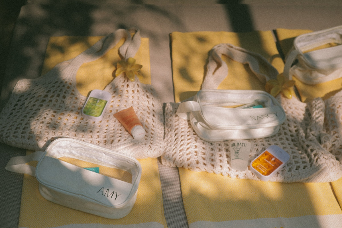 Two white mesh bags with yellow accents and toiletries.