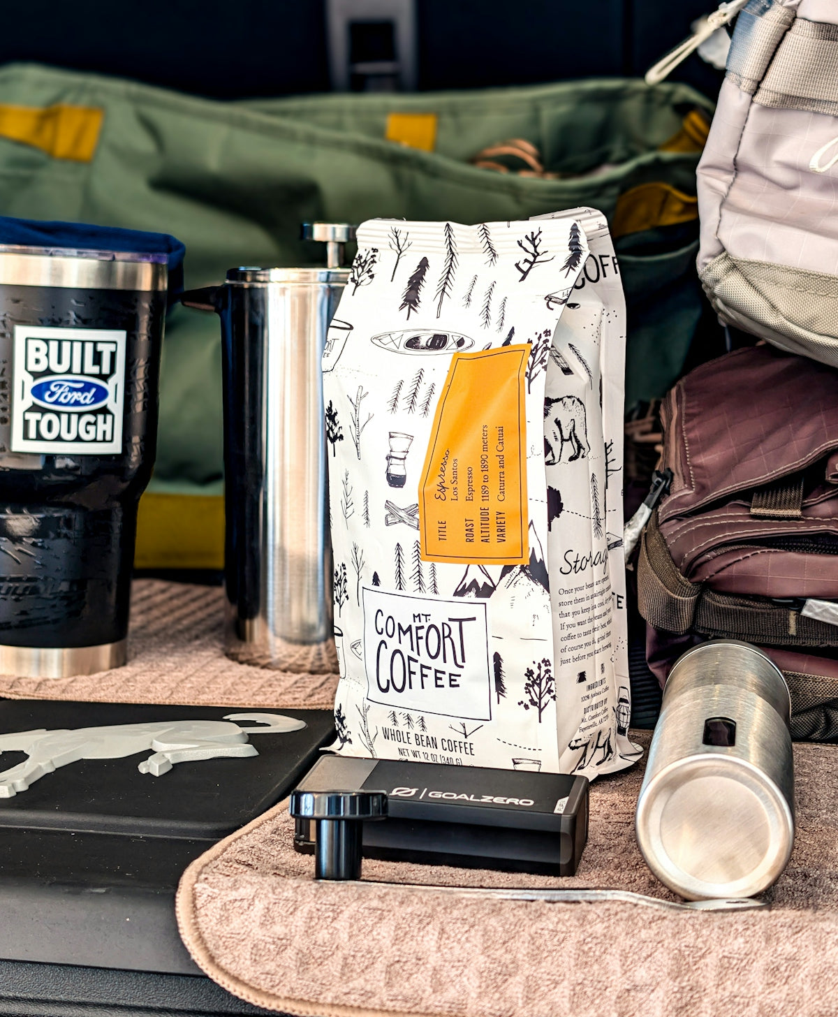 Bag of comfort coffee with travel mugs and gear