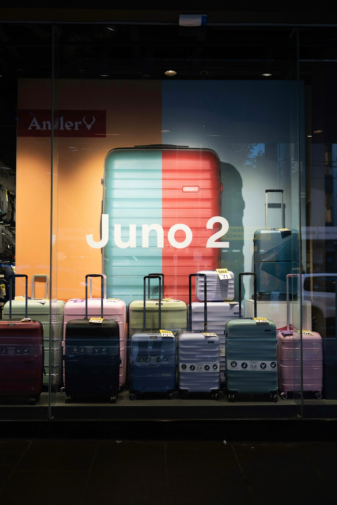 Colorful suitcases displayed in a store window